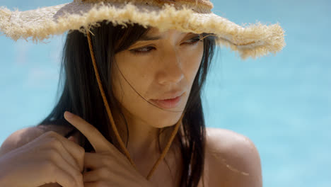Thoughtful-attractive-woman-in-a-straw-sunhat