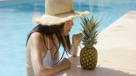 Young-woman-sipping-a-pineapple-cocktail