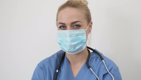 Female-doctor-in-mask-looking-at-camera