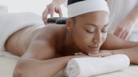 Woman-Receiving-A-Massage-With-Hot-Stone