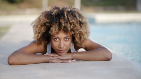 Young-Woman-Sunbathing-Near-Swimming-Pool