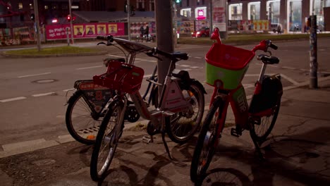 Parked-shared-bikes,-bike-sharing-docking-station-in-Berlin-city,-night