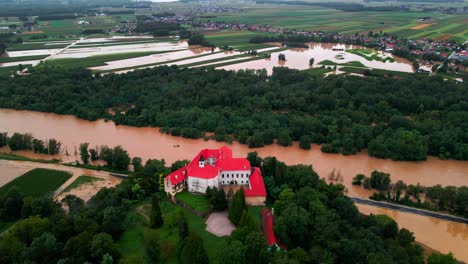Horrific-Aerial-4K-Drone-footage-of-Castle-Borl-and-flooded-villages-in-Podravje,-Slovenia,-during-August