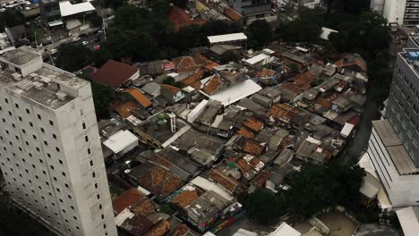Aerial-top-down-shot-Favela-District-with-destroyed-houses-in-Jakarta-City-at-cloudy-day,-Indonesia