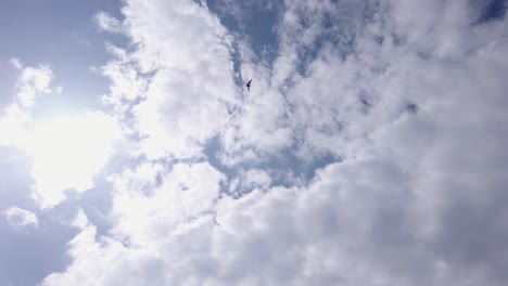 An-extreme-wide-of-an-air-trike-flying-through-the-clouds-from-below-on-a-fine-day