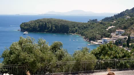 View-of-forested-rocky-cliffs-on-Corfu-Island,-beaches,-blue-sea,-and-mountains