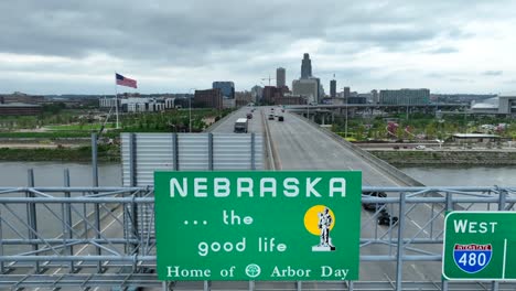 Welcome-to-Nebraska-road-sign-on-the-bridge-entering-Omaha,-NE