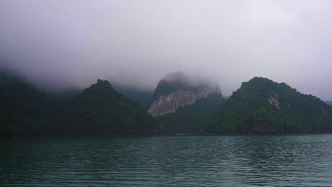 Slow-motion-shot-of-low-lying-clouds-covering-the-mountain-peaks-at-a-New-Zealand-lake