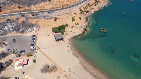 Destroyed-beach,-burned-down-by-the-fire-in-Rhodes,-Greece-during-the-wildfire-filmed-with-drone