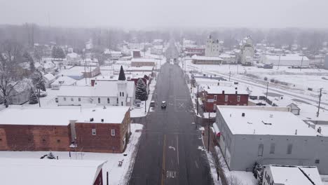 Iconic-downtown-of-American-town-during-snowfall,-aerial-view