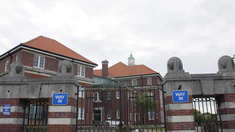 Asylum-mental-hospital-building-with-gates-entrance-establishing-shot