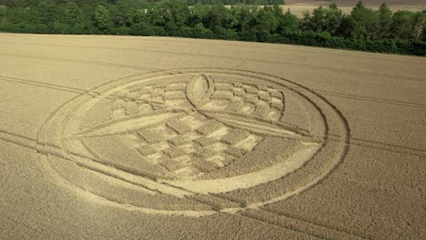 Low-angle-aerial-view-circling-South-Wonston-unique-crop-circle-on-golden-Hampshire-wheat-field
