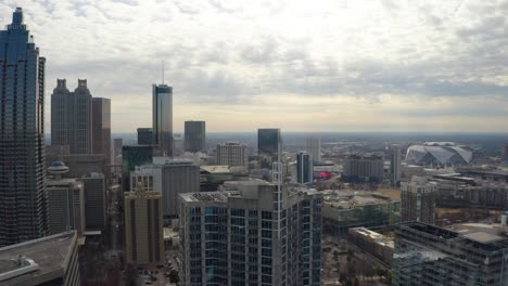 Slow-moving-aerial-drone-shot-flying-above-the-skyscrapers-in-downtown-Atlanta,-Georgia-on-a-cloudy-day-in-the-winter