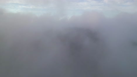 An-aerial-view-over-clouds-in-the-morning-on-Storm-King-Mountain,-located-on-the-west-bank-of-the-Hudson-River-in-NY
