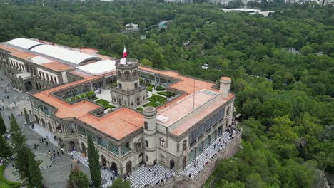 Aerial-view-in-orbit-of-Chapultepec-Castle,-in-the-background-the-lake-and-the-forest,-Mexico-City,-Mexico