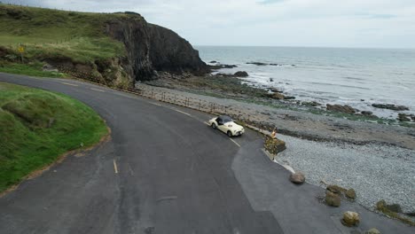 Historic-classic-rally-car-parked-in-a-beauty-spot-on-the-Copper-Coast-Drive-Waterford-Ireland-on-a-warm-summer-day