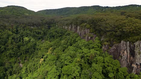 Right-to-left-Aerial-over-Twin-Falls-walk,-Springbrook-National-Park,-Gold-Coast-Hinterland,-Queensland,-Australia