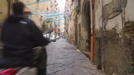 Narrow-street-of-Naples-decorated-with-football-attributes,-reveal-view