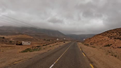 Driving-on-mountain-road-of-Tunisia-on-cloudy-rainy-day,-driver-point-of-view