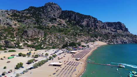 Tsambika-beach-in-Faliraki,-Rhodes-in-Greece-filmed-with-the-drone-from-above-with-Mediterranean-Sea-in-the-summer-holiday
