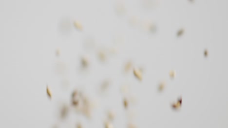 Barley-and-Grains-being-Tossed-into-the-Air-on-a-White-Background-Three-Times