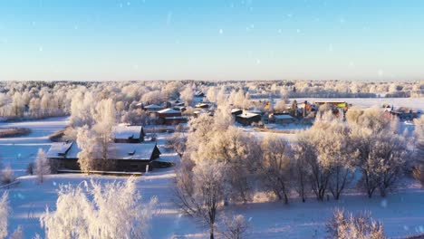 Residential-buildings-covered-in-snow-on-sunny-winter-day,-aerial-view