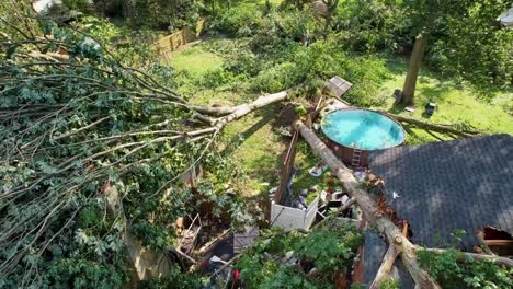 tornado-storm-damage-low-drone-flyover-cinematic-above-ground-pool-trees-toppled