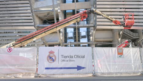 A-Real-Madrid-football-stadium-sign,-Santiago-Bernabeu,-indicates-the-team's-official-shop-location-as-it-completes-its-new-design-and-total-renovation