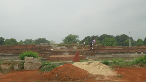 Wide-shot-of-Construction-Labourers-working-on-excavation-and-restoration-work-on-the-ruins-of-Nalanda-Mahavihara-an-ancient-Buddhist-monastic-university-that-was-demolished-by-Mughal-Invaders