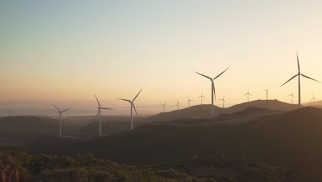 Wind-generators-in-Tarifa,-Southern-Spain-during-orange-glow-sunset-light-renewable-energy