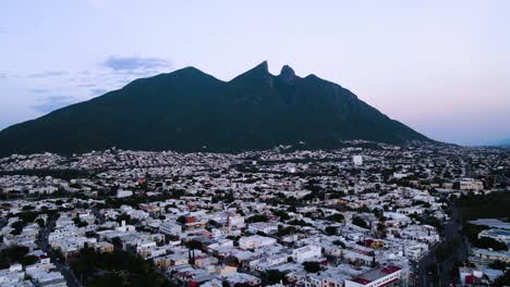 Amazing-aerial-view-of-Cerro-de-la-Silla-in-Monterrey-while-flying-over-houses