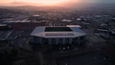 circular-drone-shot-at-sunrise-around-Geoffroy-Guichard-Stadium-also-called-"le-chaudon"-in-Saint-Etienne-City,-France