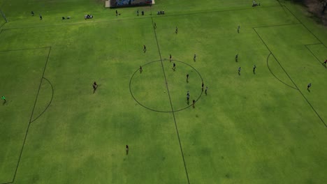 Aerial-top-down-view-over-soccer-players-playing-amateur-football-match-in-Perth,-Australia