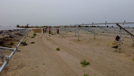 Engineers-And-Technicians-Installing-Photovoltaic-Panels-At-Solar-Farm-In-Jambur,-Gambia,-West-Africa