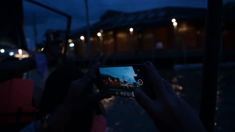 Foreign-and-local-tourists-taking-videos-and-photos-of-the-local-community-at-Amphawa-Floating-Market,-Thailand