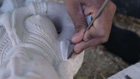 Close-up-scene-of-a-sculptor-carving-marble-stone-with-his-tools-to-create-magnificent-images-of-God