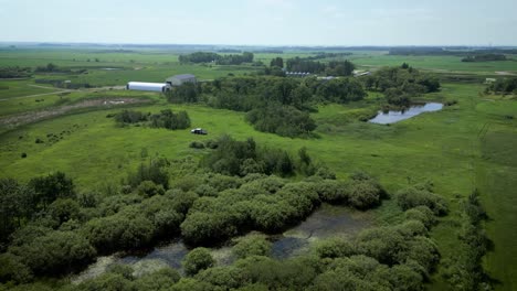 LONG-CLIP-Slow-Motion-Orbit-Encroaching-Forest-Habitat-Slough-Lake-Disruption-on-Agricultural-Cattle-Grain-Farm-in-Western-Canada-Manitoba-Saskatchewan-Alberta