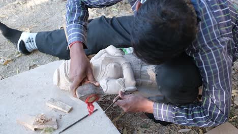 close-up-scene-in-which-a-sculptor-is-carving-a-statue-out-of-marble-with-his-tools