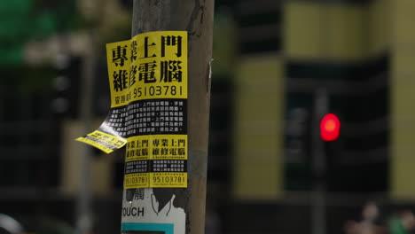 Leaflets-offering-bank-loans-affixed-to-electric-poles-in-Hong-Kong,-China