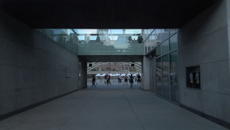 Exterior-wide-shot-of-people-gathering-and-reflected-in-windows-at-Toronto-City-Hall