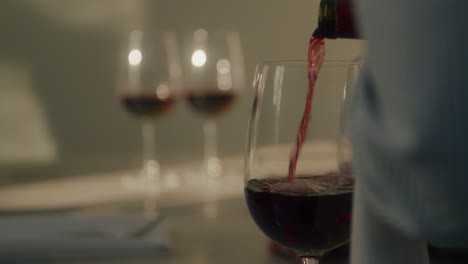 Close-up-of-Server-Pouring-Glasses-of-Red-Wine