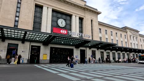 Front-Entrance-View-To-Genève-Cornavin-Railway-Station-With-People-And-Bendy-Bus-Seen-In-Background