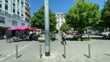 Sliding-establishing-shot-from-moving-tram-of-streets-of-Frankfurt,-summer-day