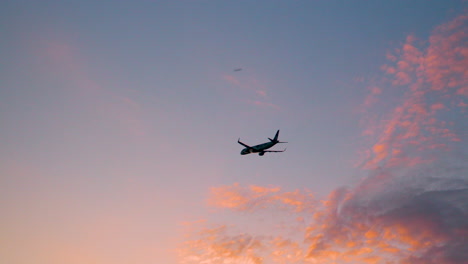 LOT-Polish-Airlines-Jet-Plane-Ascending-into-Sunset-Sky-With-Pink-Clouds,-Airplane-Departure-Summer-Vacation