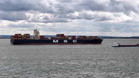 MSC-Madeleine-container-ship-sailing-up-river-Thames-Estuary-UK-Aerial-drone