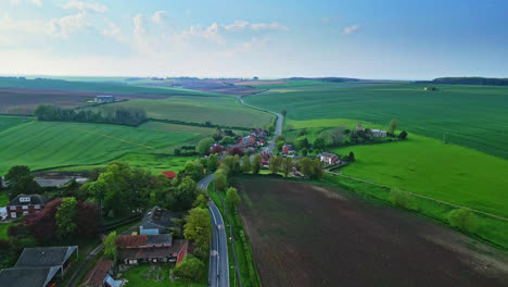 Aerial-drone-scene-captures-Burwell-village,-once-a-medieval-market-town,-amidst-country-fields,-vintage-red-brick-houses,-and-the-decommissioned-Saint-Michael-parish-church-on-Lincolnshire's-Wolds