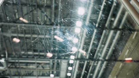 Scraped-plexiglass-at-hockey-arena-with-out-of-focus-spotlights-in-background