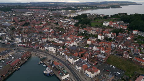 Establishing-Drone-Shot-Over-Scarborough-Harbour-and-Town-on-Overcast-Morning