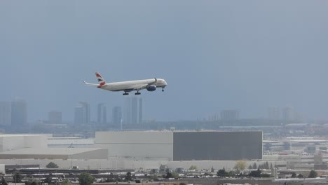 Tracking-shot-of-a-white-airplane-from-British-Airways-plane-mid-fly-with-a-clear-blue-sky-as-a-background-arriving-at-the-Toronto-Airport