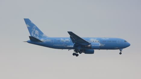 tracking-shot-of-a-blue-plane-from-Air-Drake-mid-fly-arriving-at-the-Toronto-Pearson-International-Airport